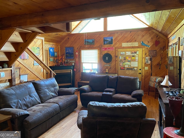 living room featuring wood walls, a wealth of natural light, and hardwood / wood-style flooring