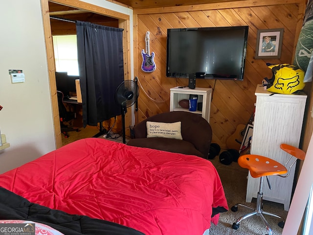 carpeted bedroom with wood walls