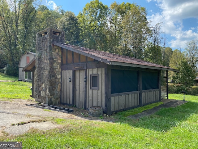 view of outbuilding featuring a yard