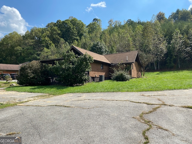 view of property exterior with a yard