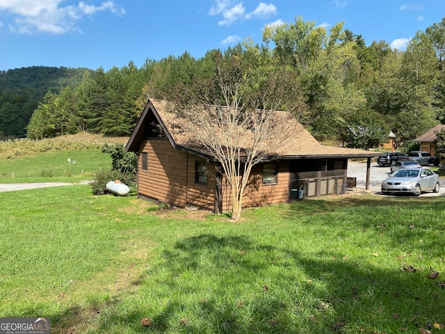 view of side of property with a yard