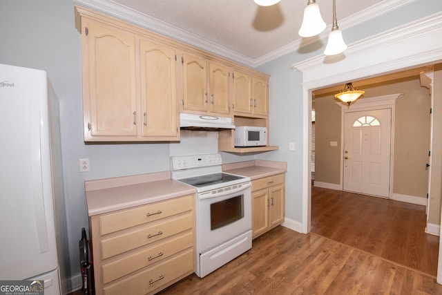 kitchen featuring white appliances, dark hardwood / wood-style floors, pendant lighting, and ornamental molding