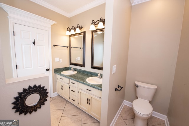 bathroom with toilet, vanity, tile patterned floors, and ornamental molding