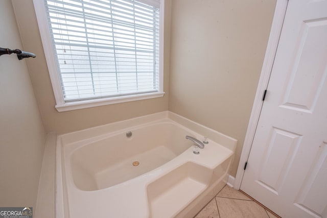 bathroom with a bath and tile patterned floors