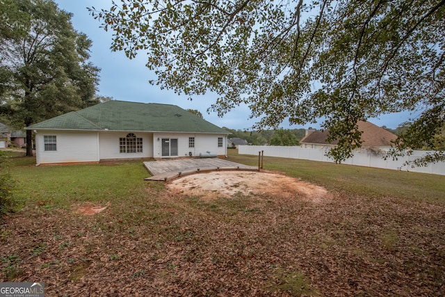 back of property with a patio and a yard