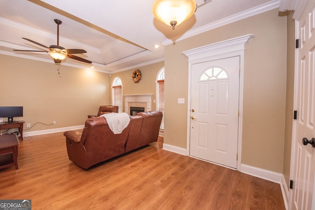 foyer with ceiling fan, light hardwood / wood-style floors, and crown molding