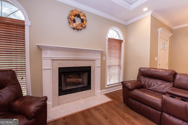 living room featuring a wealth of natural light, wood-type flooring, and crown molding