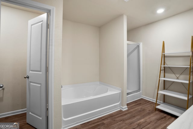 bathroom with wood-type flooring and independent shower and bath