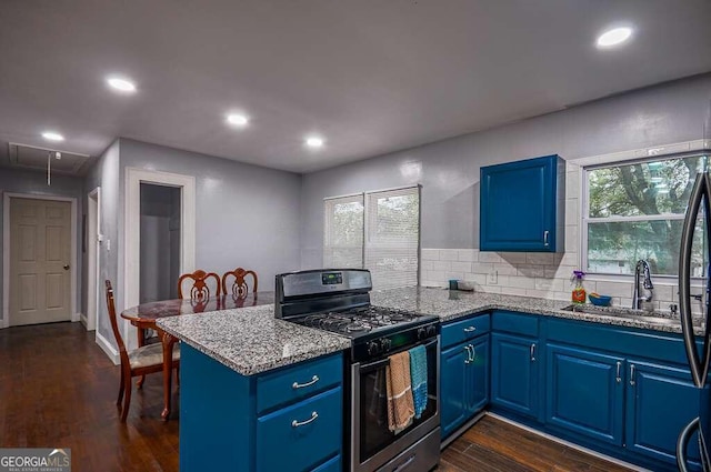 kitchen featuring dark wood-type flooring, blue cabinets, sink, stainless steel gas stove, and light stone countertops