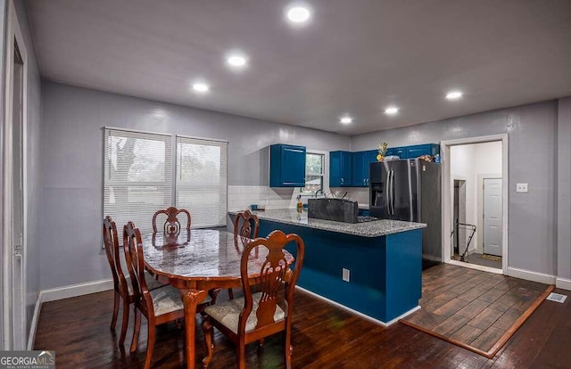 dining space featuring dark wood-type flooring