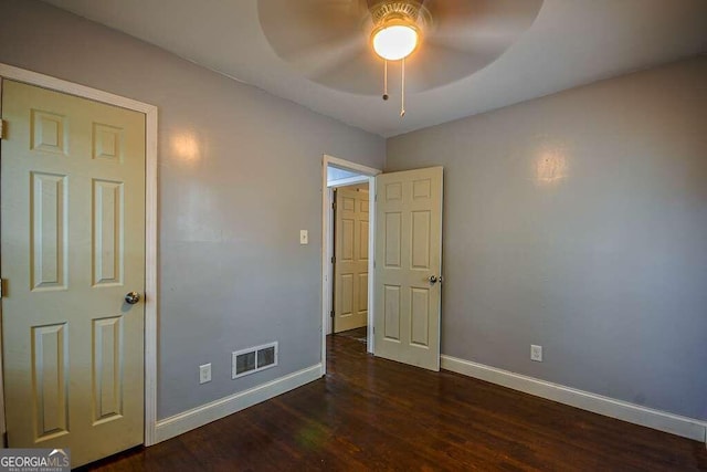 unfurnished bedroom featuring dark wood-type flooring and ceiling fan