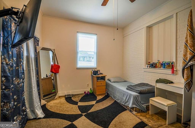 bedroom featuring carpet flooring, ceiling fan, and crown molding