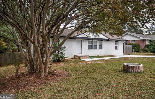 view of front of house featuring an outdoor fire pit and a front yard