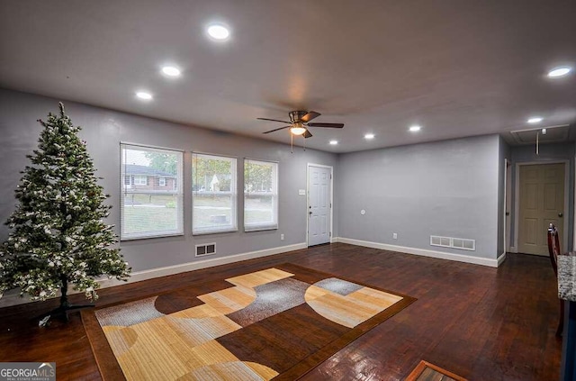 spare room with dark hardwood / wood-style flooring and ceiling fan