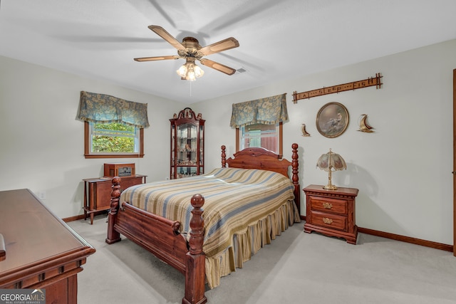 bedroom featuring light carpet and ceiling fan