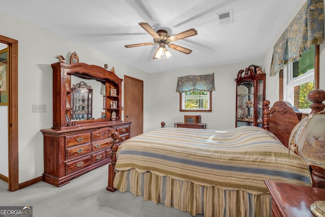 bedroom featuring light carpet and ceiling fan