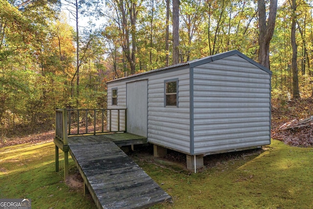 view of outbuilding featuring a lawn