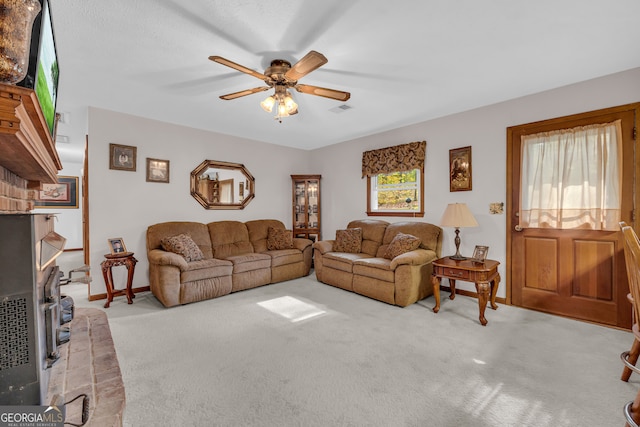 living room featuring ceiling fan, plenty of natural light, and light carpet