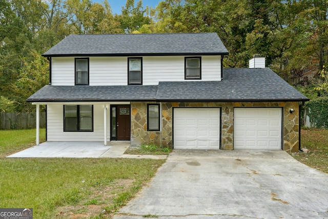 view of front property featuring a garage and a front yard