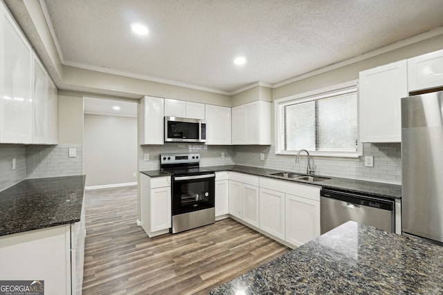 kitchen featuring stainless steel appliances, white cabinets, and sink