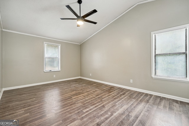 empty room featuring a wealth of natural light, hardwood / wood-style floors, lofted ceiling, and ceiling fan