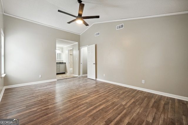 interior space featuring ornamental molding, dark hardwood / wood-style flooring, ceiling fan, and vaulted ceiling