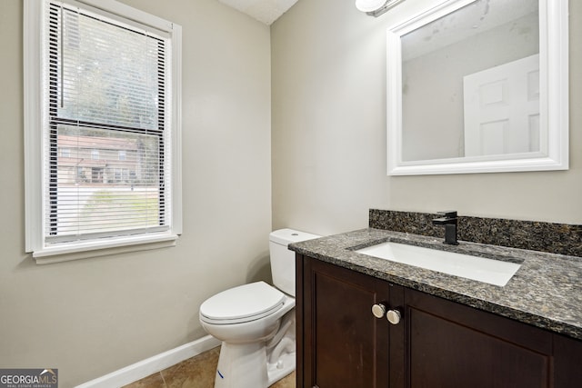 bathroom with tile patterned floors, vanity, and toilet