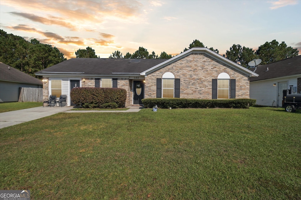 ranch-style house with a lawn