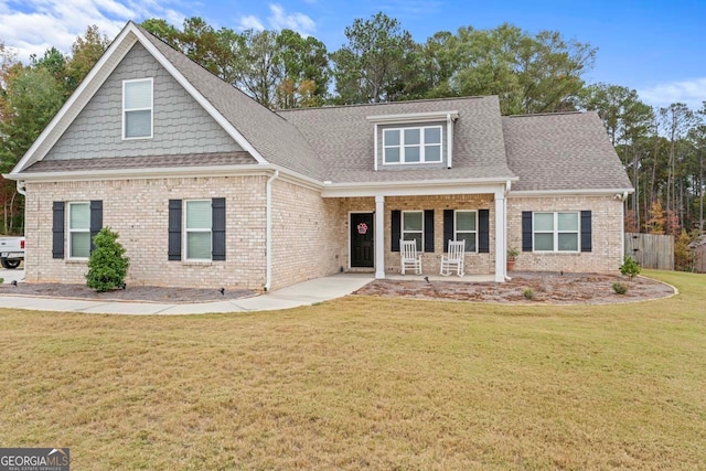 craftsman-style home with a front yard and a porch