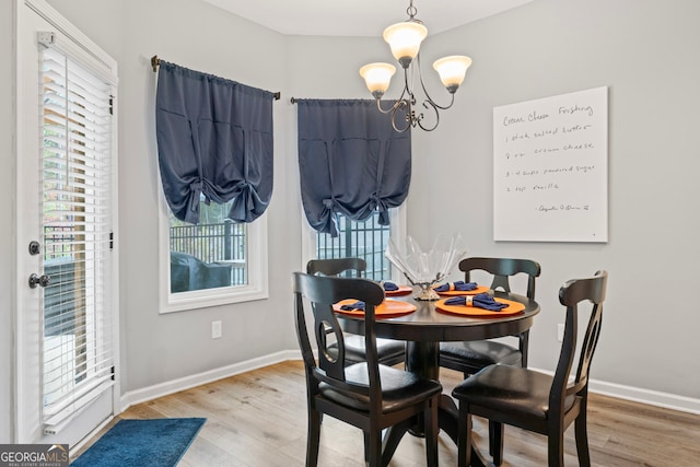 dining room with a notable chandelier and hardwood / wood-style flooring