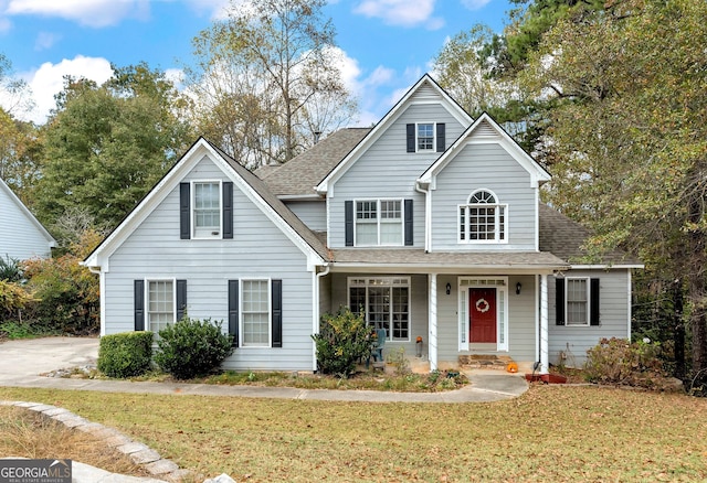 front of property with a porch and a front yard