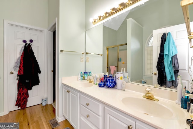 bathroom with vanity, wood-type flooring, and a shower with shower door