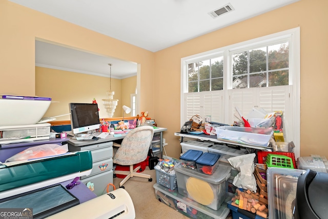 carpeted home office with a chandelier and crown molding