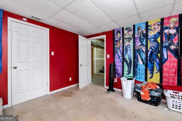 unfurnished bedroom featuring carpet and a paneled ceiling