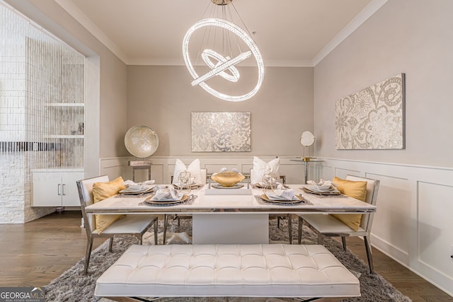 dining area with dark hardwood / wood-style flooring, a notable chandelier, and ornamental molding