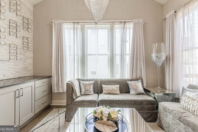 living room featuring light hardwood / wood-style flooring and a notable chandelier