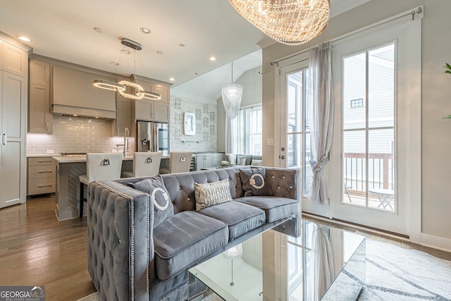 living room with hardwood / wood-style floors and an inviting chandelier