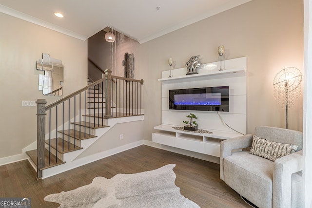 living room with dark hardwood / wood-style floors and crown molding