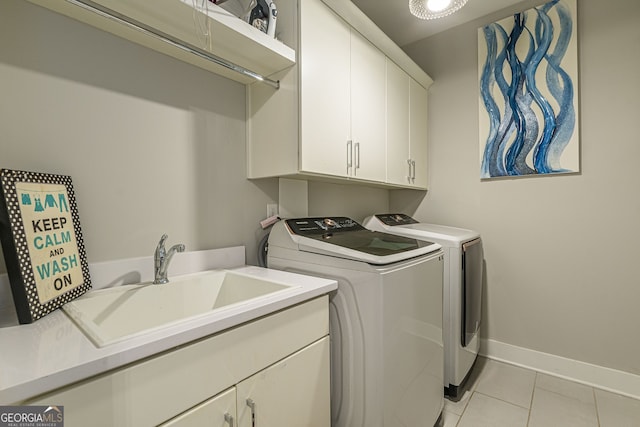 clothes washing area featuring sink, cabinets, independent washer and dryer, and light tile patterned floors