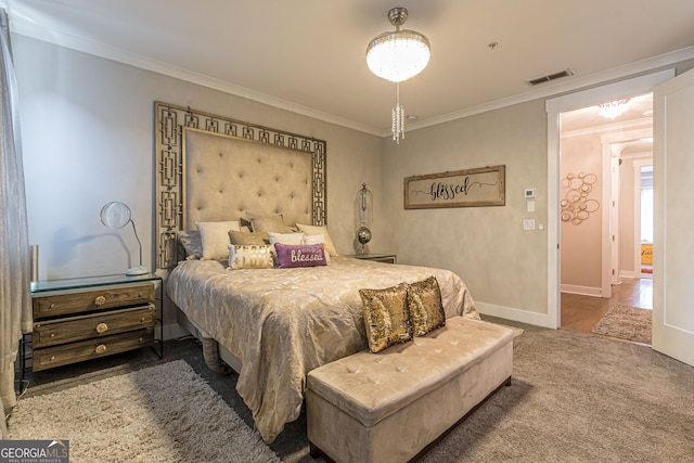 bedroom featuring ornamental molding and carpet