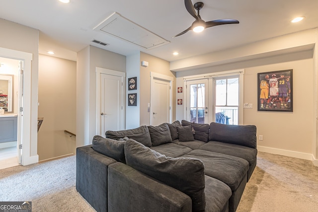 carpeted living room with ceiling fan and french doors