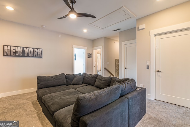 carpeted living room with ceiling fan