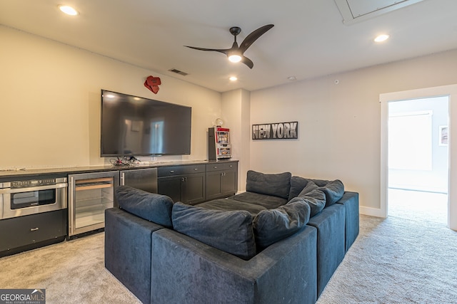 carpeted living room with ceiling fan and wine cooler