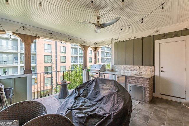 view of patio featuring grilling area, sink, a balcony, exterior kitchen, and ceiling fan