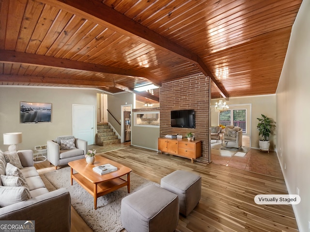 living room with light wood-type flooring, a notable chandelier, lofted ceiling with beams, and wooden ceiling