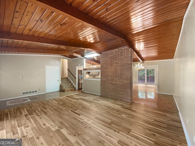 unfurnished living room featuring wooden ceiling, hardwood / wood-style flooring, an inviting chandelier, and vaulted ceiling with beams