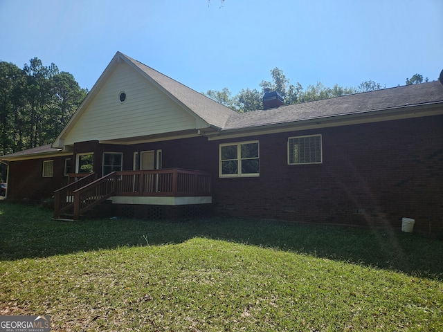 rear view of property featuring a yard