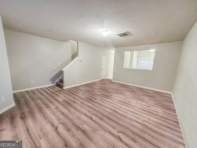 interior space with light hardwood / wood-style floors and a textured ceiling