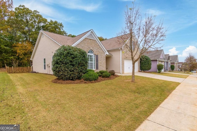 view of front of home with a garage and a front lawn