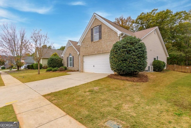 front facade with cooling unit, a garage, and a front yard